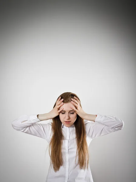 Headache. Woman in white is suffering from headache.