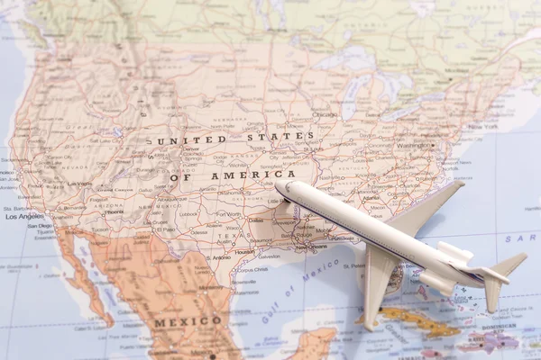 Travel destination USA. Passenger plane miniature on a map