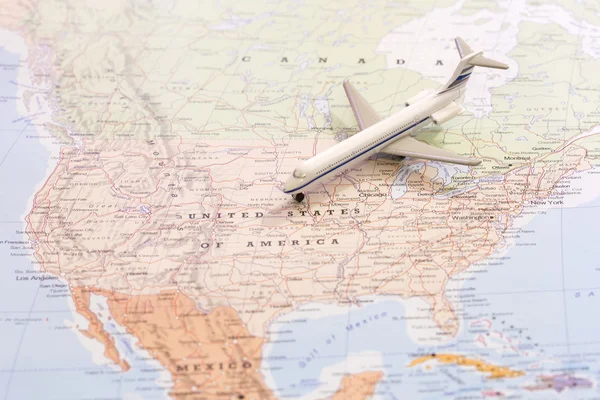 Travel destination USA. Passenger airplane miniature on a map