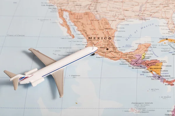 Passenger plane on the map with destination Mexico