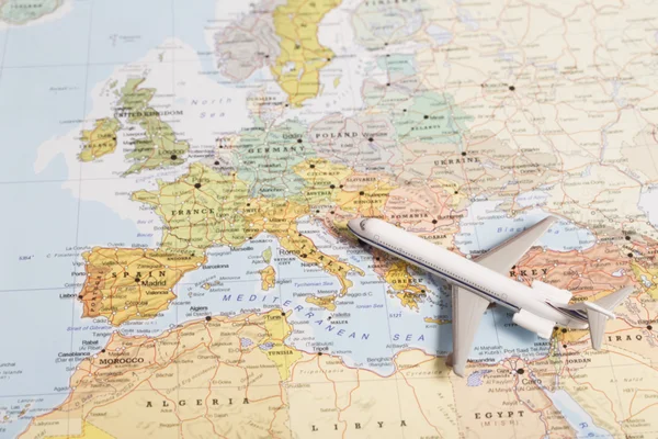 Travel destination Europe. Passenger plane miniature over the ma