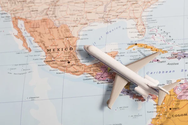 Travel destination Mexico. Passenger plane miniature over the ma