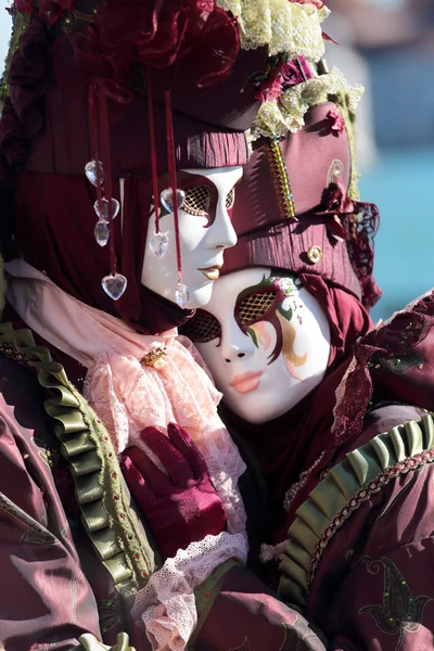 Hugging couple of masks at the Carnival of Venice