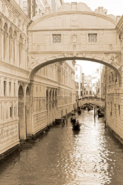 Gondolas through the canals of Venice, sepia tone