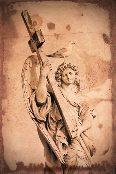 Grunge textured marble statue of an Angel, in Rome, with cross and seagull