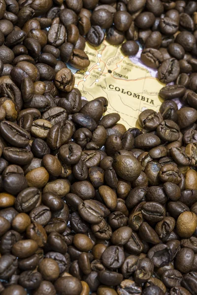 Map of Colombia under a background of coffee beans