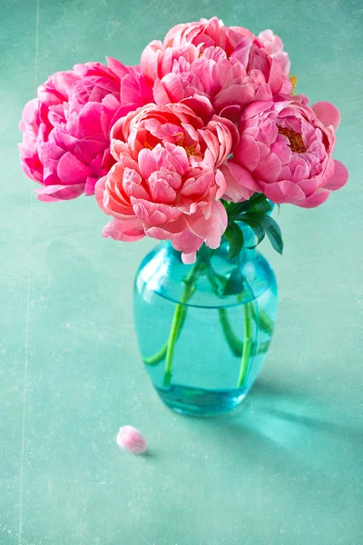 Pink peonies on a green background
