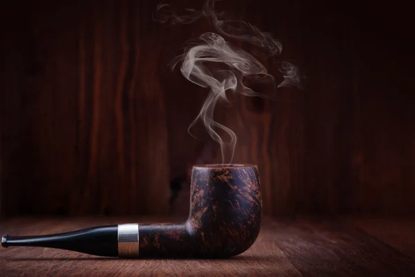 Smoking pipe on a wooden table