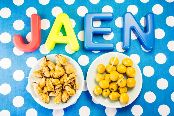 Jaen made of plastic letters, blue dotted background