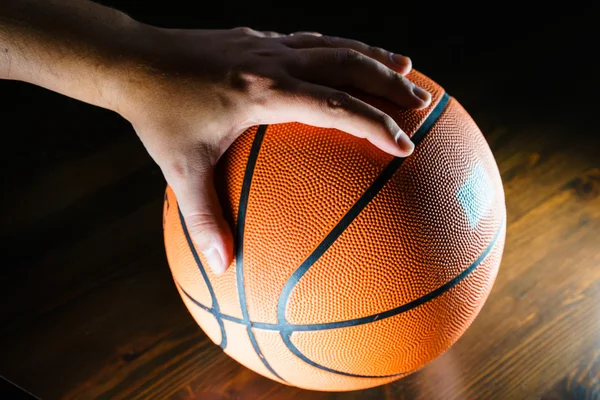 Close-up of man\'s hand over basketball