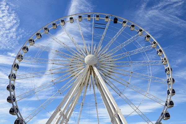 Ferris Wheel of Liverpool over blue sky.