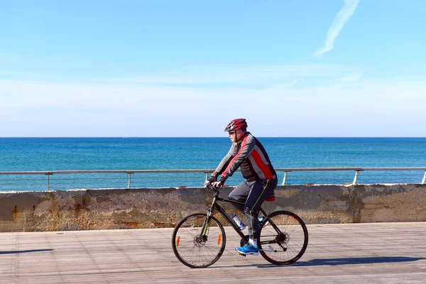 Israeli elderly man rides a bicycle