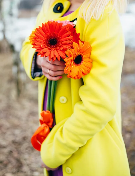 Girl holds flowers, bright colors background