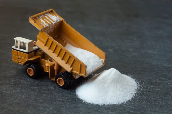 Model of big mining dump-body truck with white sugar