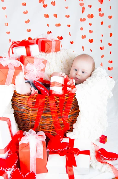 Gift basket with gift boxes, hearts and Cupid. Valentines Day