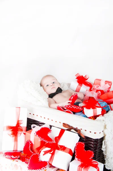 Gift basket with gift boxes, hearts and Cupid. Valentines Day