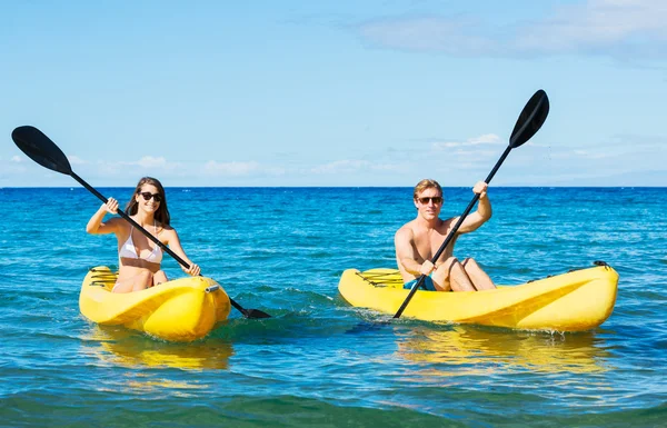 Man and Woman Kayaking in the Ocean