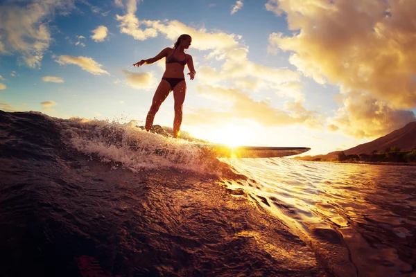 Woman Surfing at Sunset