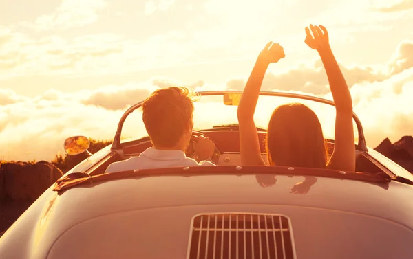 Young Couple Wathcing the Sunset in Vintage Sports Car