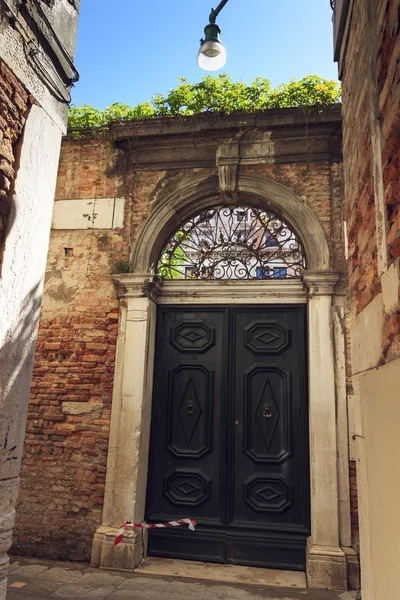 Beautiful view of Venice narrow street and antique wooden door. sunny day cityscape with historical houses and traditional architecture. Italy travel destination scenic. famous European Union places detail