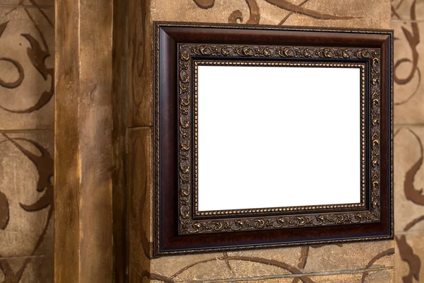 Wooden old frame on the wall with empty content