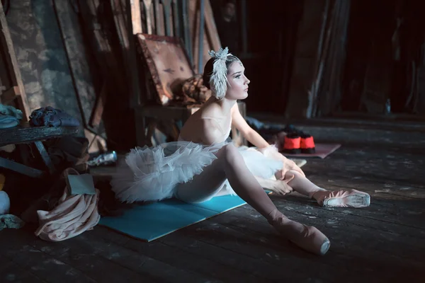 Ballerina sitting on the warm-up backstage