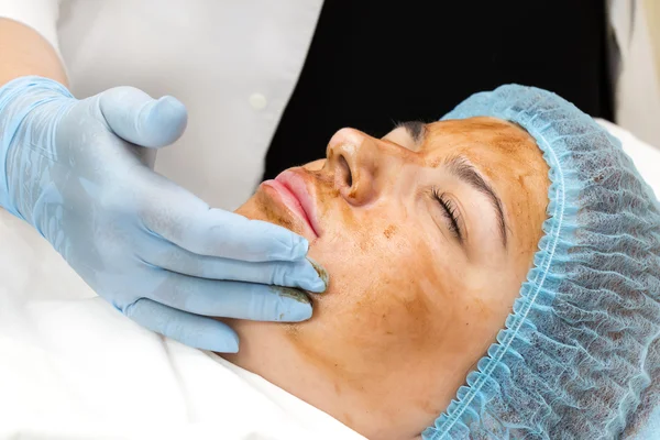 Woman passes treatment mask facial