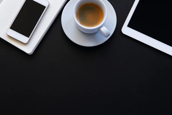 Top view of workplace with coffee cup and tablet