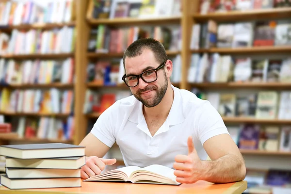 Portrait of a man with glasses in a bookstore