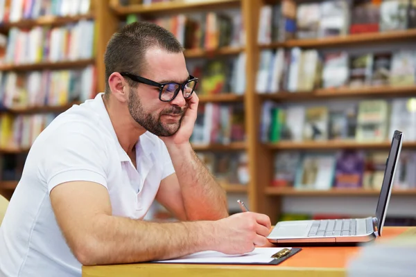 Pensive man working in the library