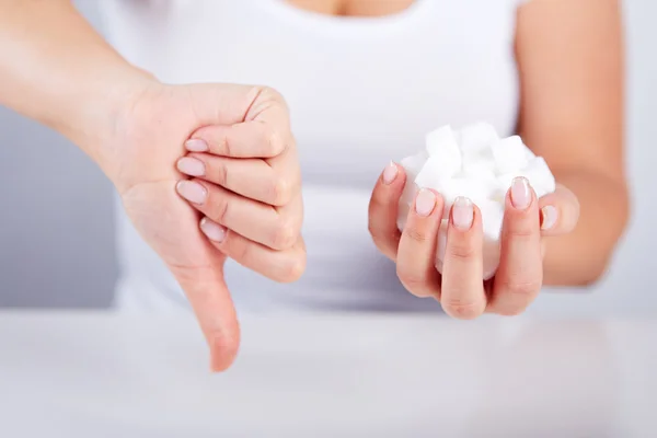 Woman holds in hand of sugar cubes
