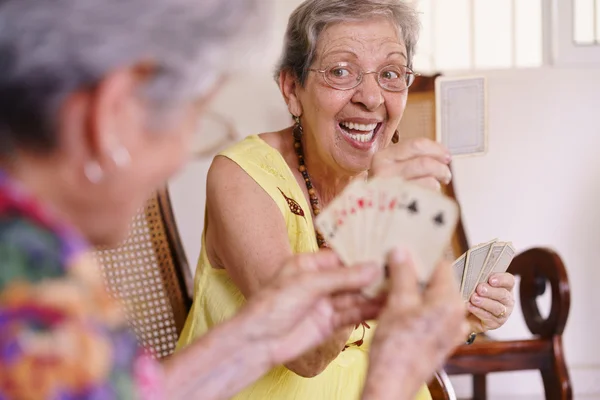 Old Women Enjoy Playing Card Game In Hospice