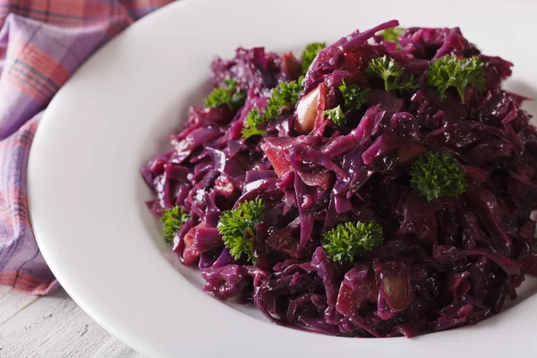 Braised red cabbage close-up on a plate. horizontal