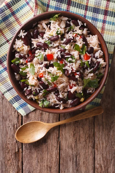 Rice with red beans and vegetables in a bowl. vertical top view