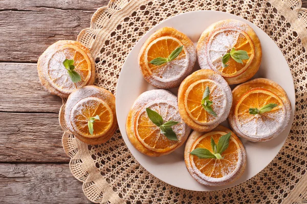 Cookies with oranges, decorated with mint and powdered sugar clo