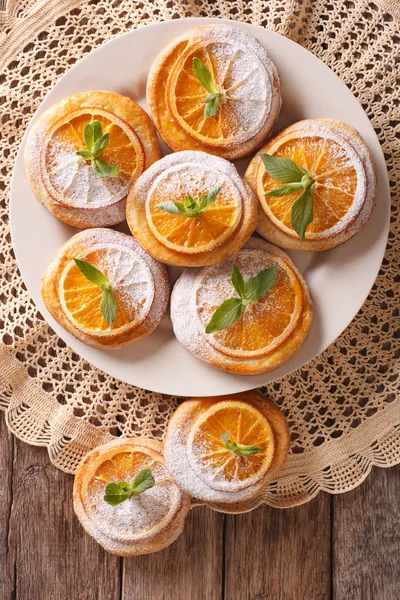 Cookies with oranges, decorated with mint and powdered sugar clo