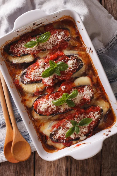 Italian eggplant baked with cheese in tomato sauce close up in b