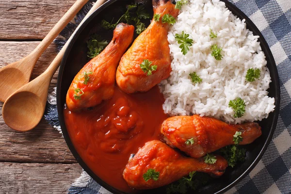Baked chicken with chilli sauce Sriracha and Rice close-up. hori