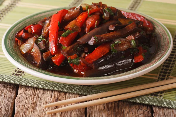 Eggplant Stir-Fry from Asian-style close-up on a plate. horizon