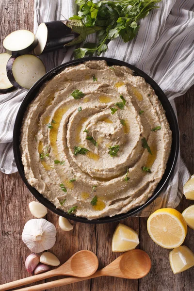 Arabic food baba ghanoush close-up and ingredients. vertical top