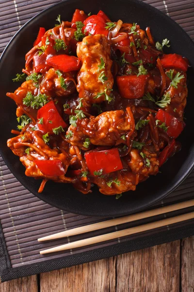 Pork with vegetables in a spicy sauce Asian style. Vertical top