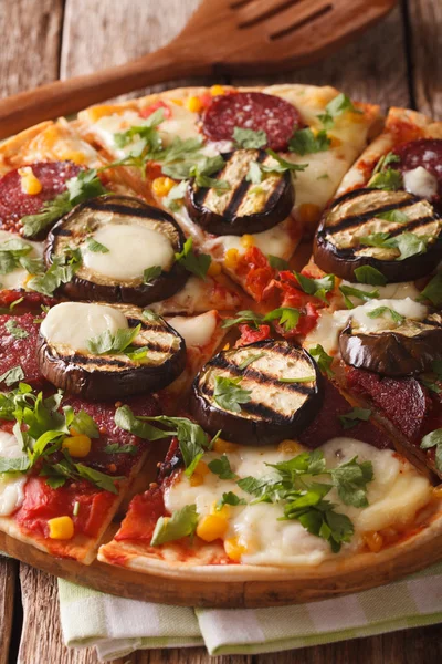 Italian pizza with eggplant, sausage, corn and cheese macro on a