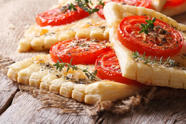 Traditional puff pastry with tomatoes, cheese and herbs