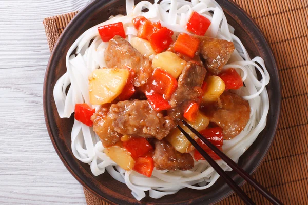Rice noodles with pork meat in sweet and sour sauce  top view