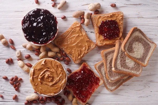 Sandwiches with peanut butter and jelly horizontal top view