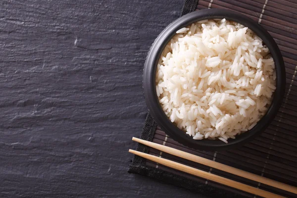 Japanese food: rice in a black bowl horiozntal top view