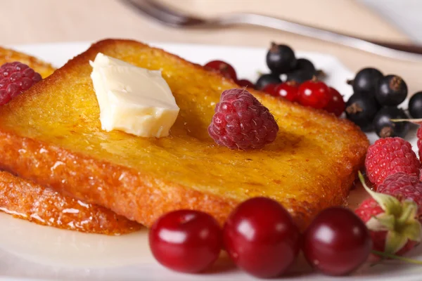 French toast with fresh berries macro on a plate. horizontal