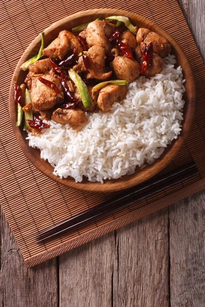 Rice with spicy kung pao chicken. Vertical top view