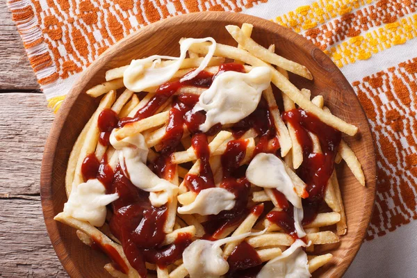 Poutine - french fries with gravy and cheese. Horizontal top vie