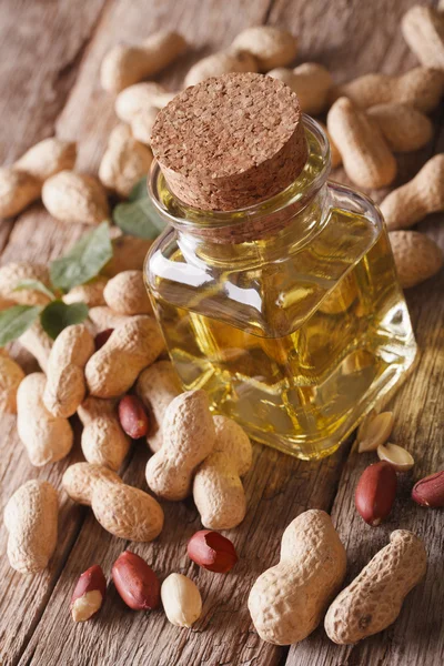 Aromatic natural peanut oil in a glass jar close up on the table